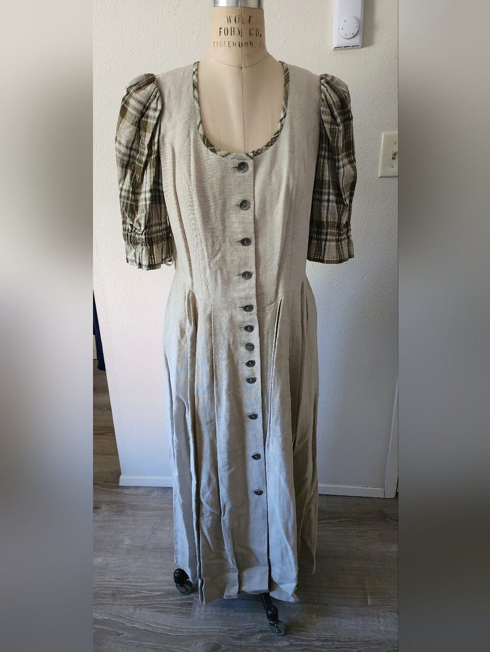 Vintage-style dirndl dress featuring a beige linen-like bodice with brown button